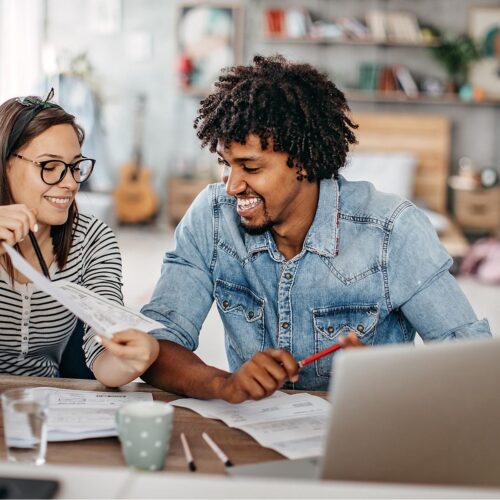 Happy couple going over expenses