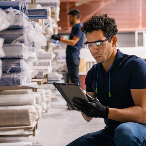 worker doing inventory at wood factory