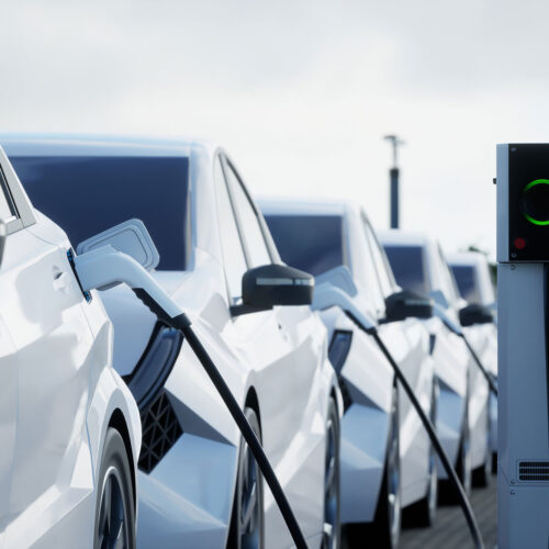 line of electric cars charging